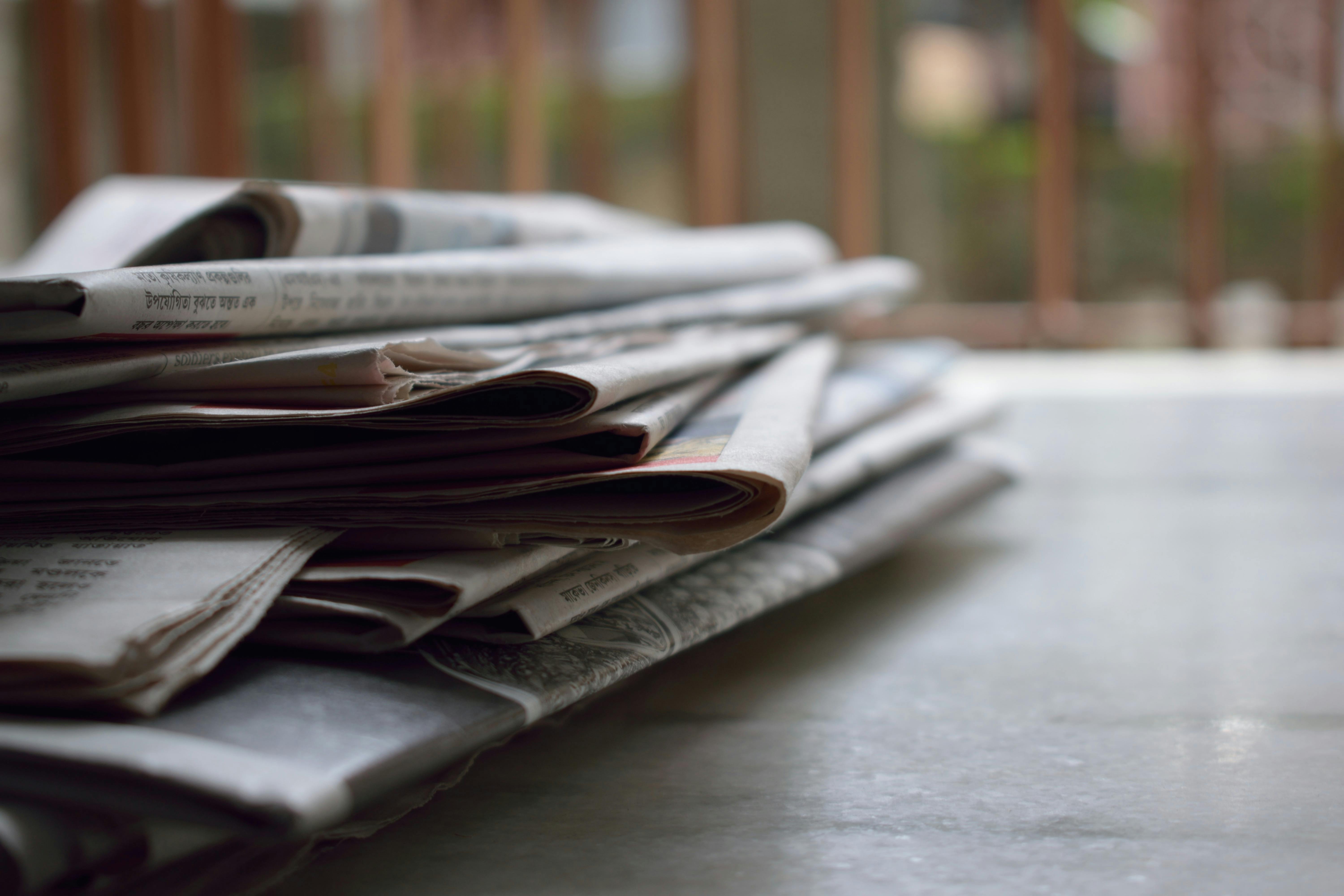 The Press — stacked newspapers